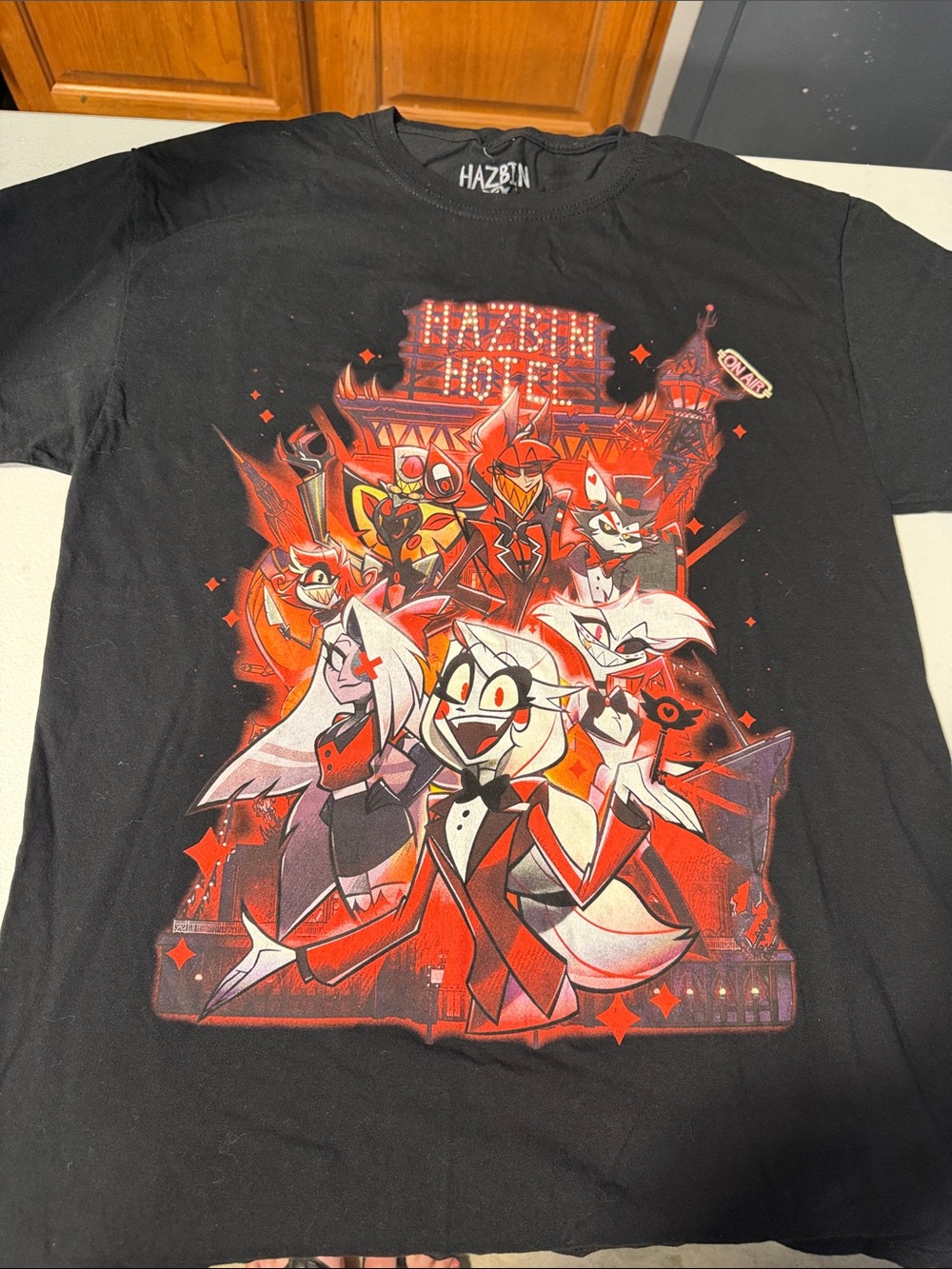 Hot Topic Black Tee with Red & White Hazbin Hotel Cast Graphic